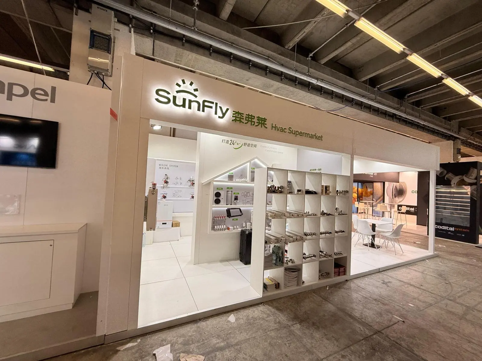 A stylish exhibition booth showcasing modern Scandinavian furniture and decor elements.