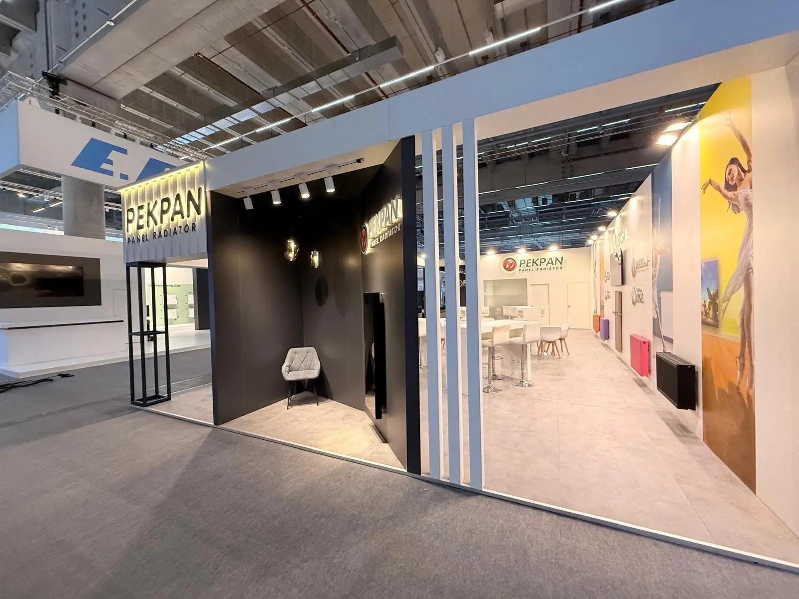 A stylish exhibition booth showcasing modern Scandinavian furniture and decor elements.