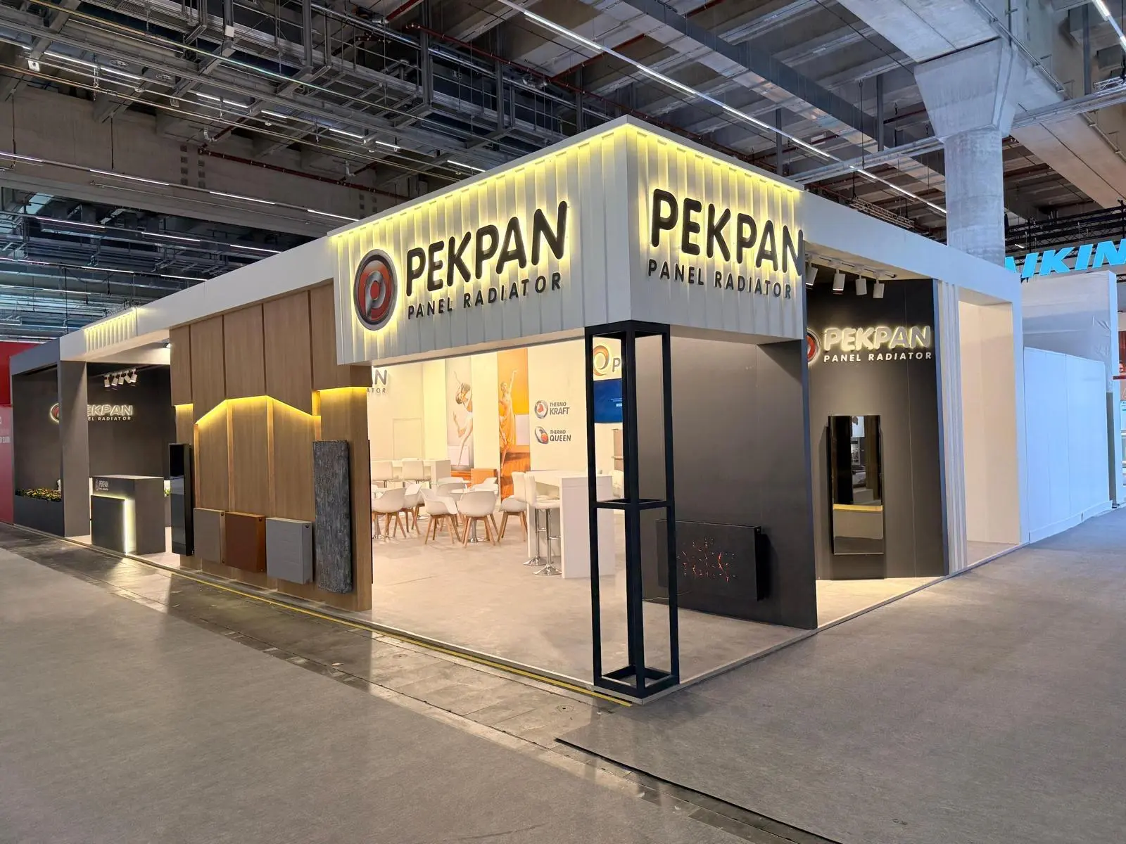A stylish exhibition booth showcasing modern Scandinavian furniture and decor elements.