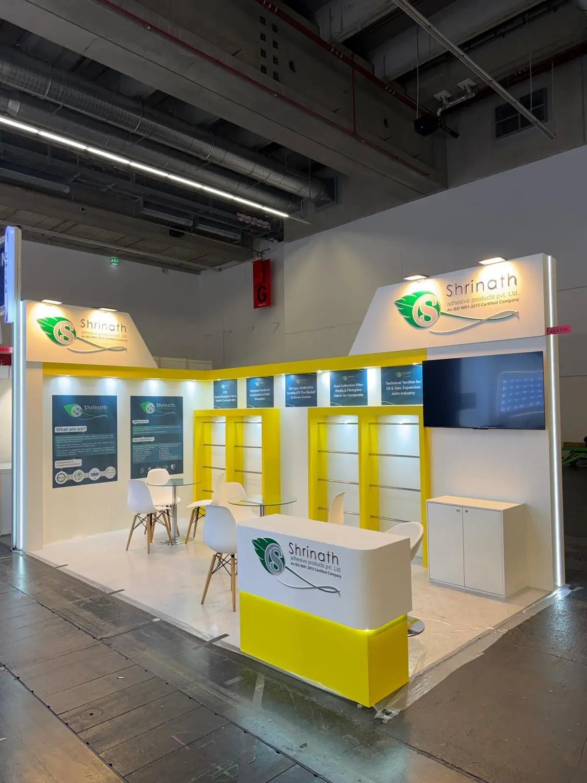 A stylish exhibition booth showcasing modern Scandinavian furniture and decor elements.